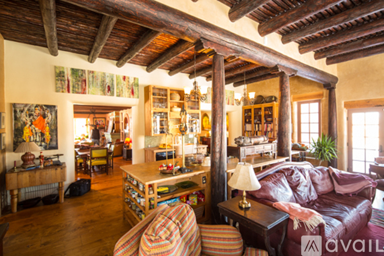 A living room with a brown couch and a wooden table.