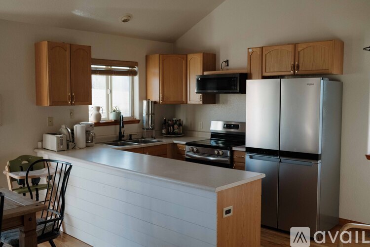 A kitchen with wooden cabinets and stainless steel appliances.