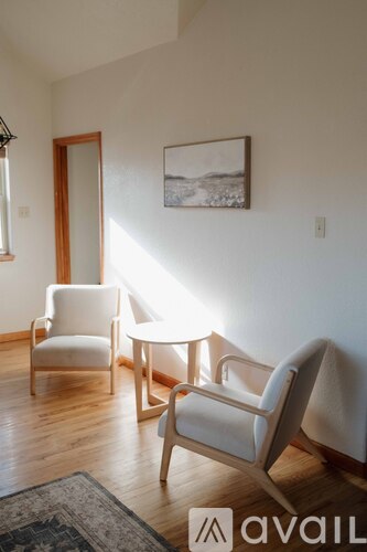 A living room with two chairs and a table.