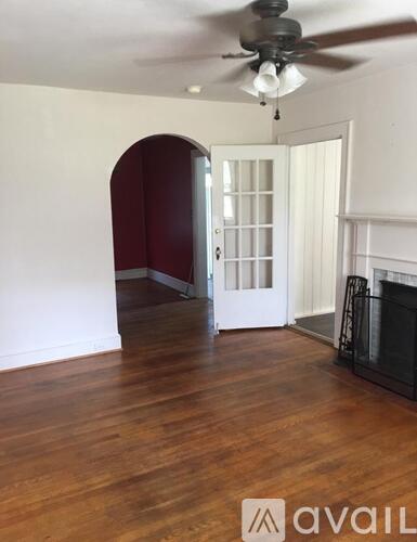 A room with a fireplace and a ceiling fan.