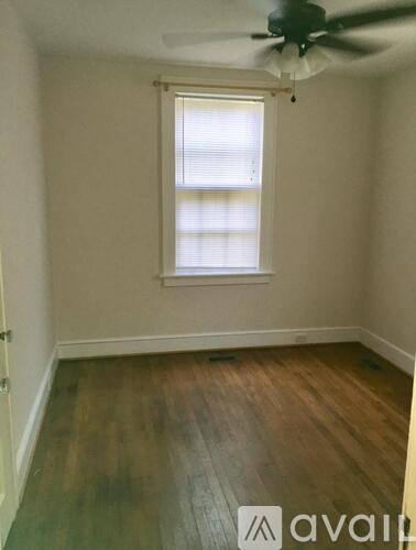 A room with a window and a ceiling fan.