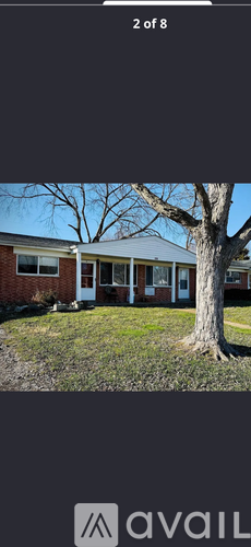 A house with a tree in front of it.