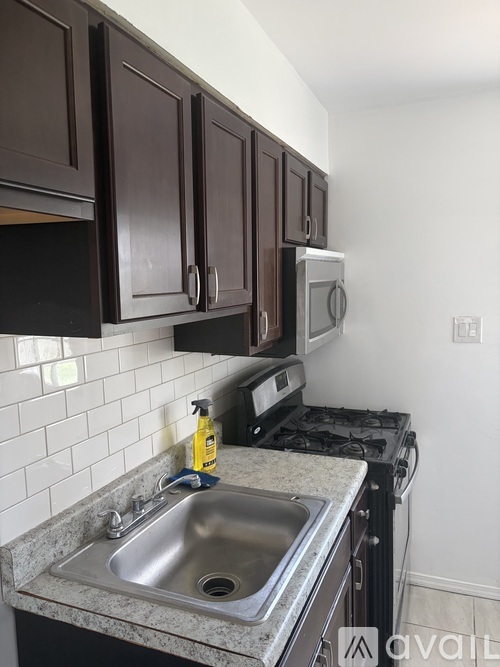 A kitchen with brown cabinets and a granite countertop.