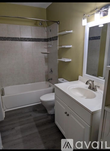 A bathroom with a white sink and a white toilet.