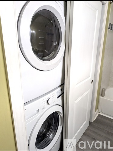 A white washing machine and dryer in a small laundry room.