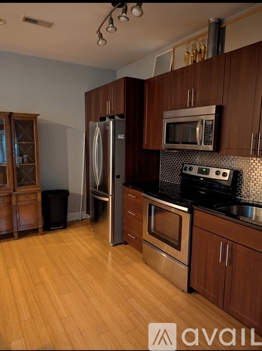 A kitchen with wooden cabinets and stainless steel appliances.