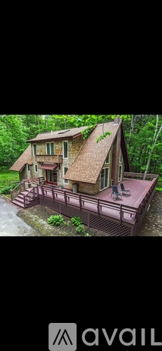 A house with a brown roof and a deck.