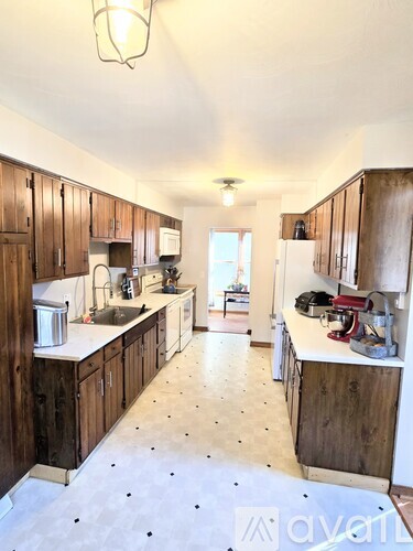 A kitchen with wooden cabinets and a white countertop.