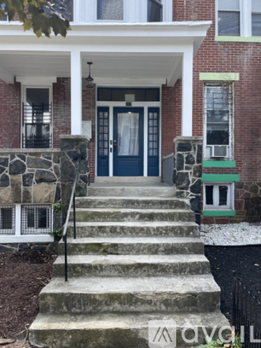 A house with a blue door and a white porch.