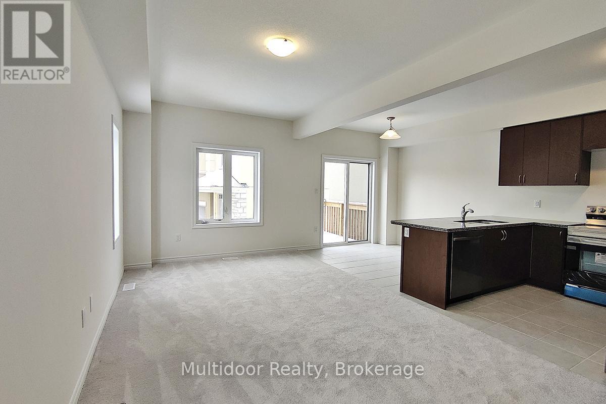 A spacious multidoor realty brokerage office with a kitchenette.