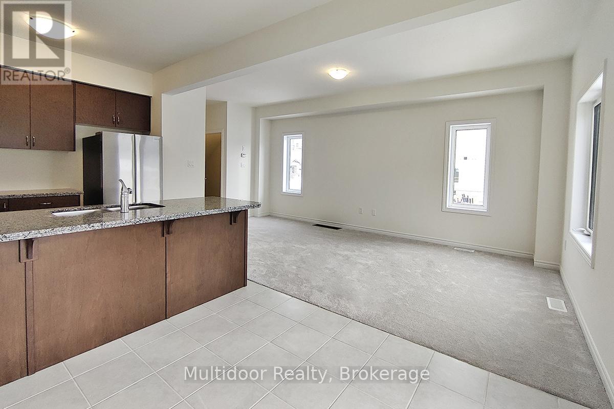 A kitchen with brown cabinets and a granite countertop.