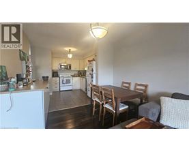 A kitchen with a dining table and chairs.