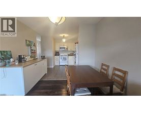 A kitchen with a table and chairs in the middle of the room.