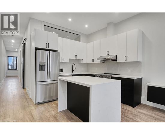 A modern kitchen with white cabinets and a central island.