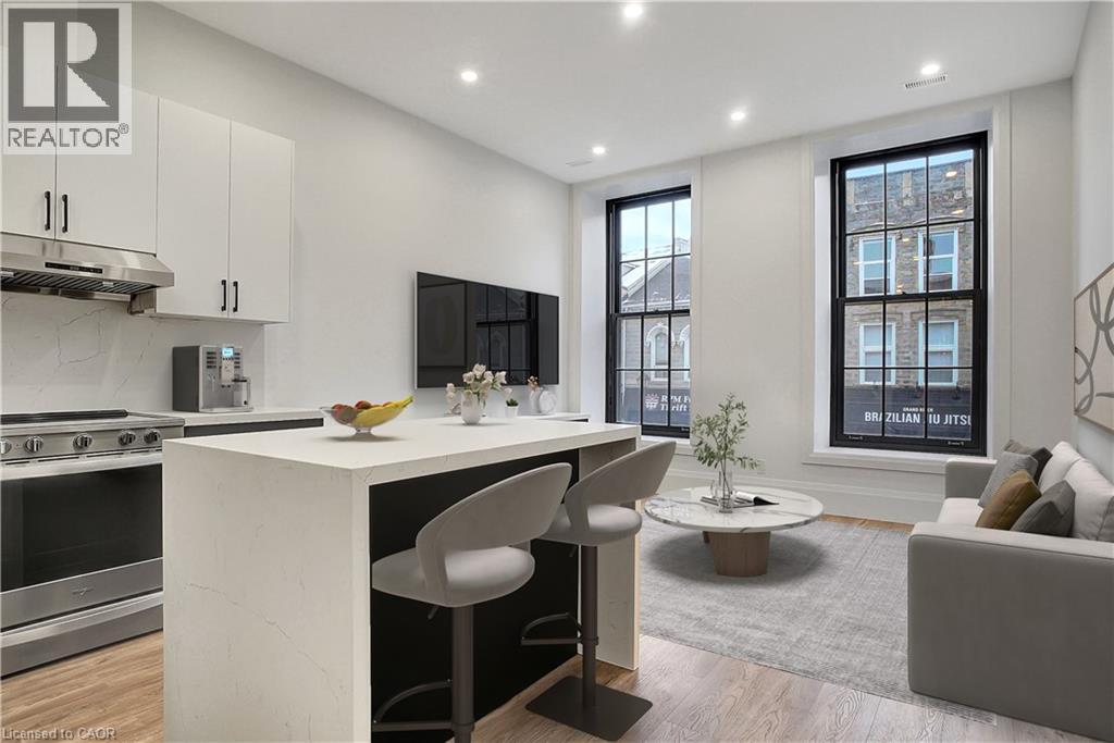 A modern kitchen with white cabinets and a large island.