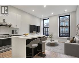 A modern kitchen with white cabinets and a large island.