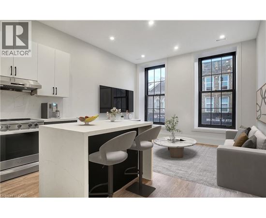 A modern kitchen with white cabinets and a large island.