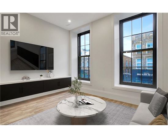 A living room with a flat screen TV mounted on the wall.