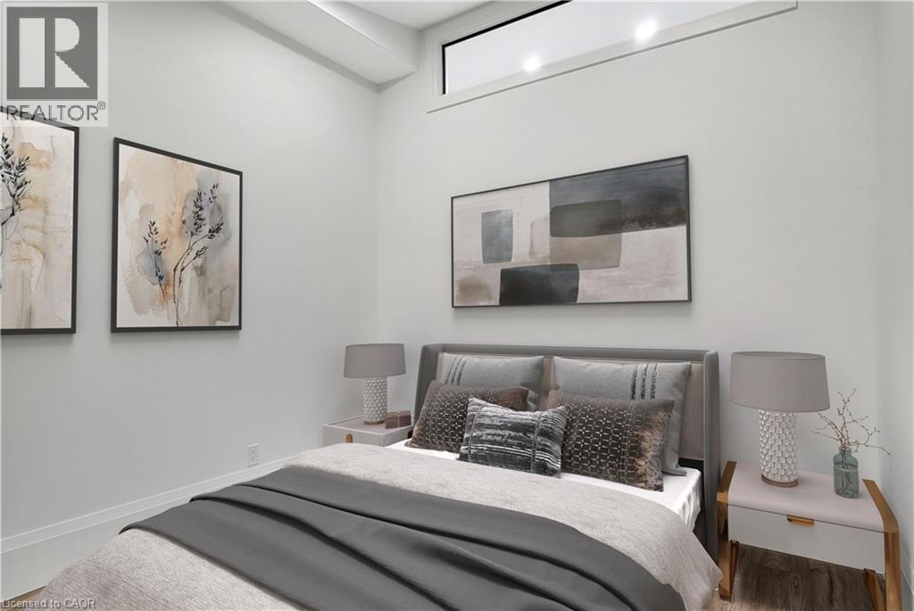 A bedroom with a large bed and two framed pictures on the wall.