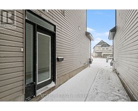 A snowy alleyway with buildings on either side and a house in the distance.