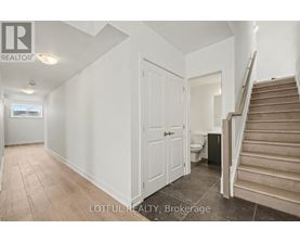 A room with a staircase leading to the upper floor.