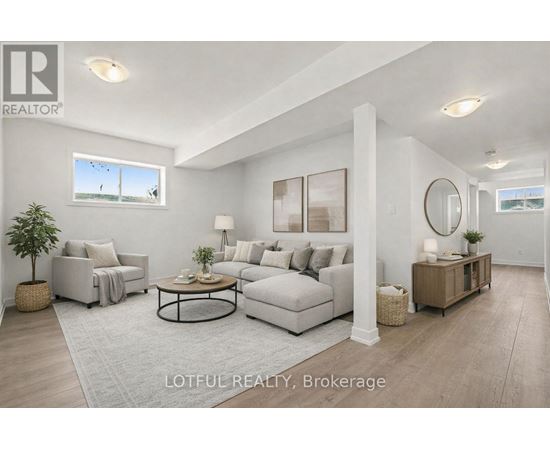A spacious room with wooden flooring and white walls, with a staircase leading to another level.