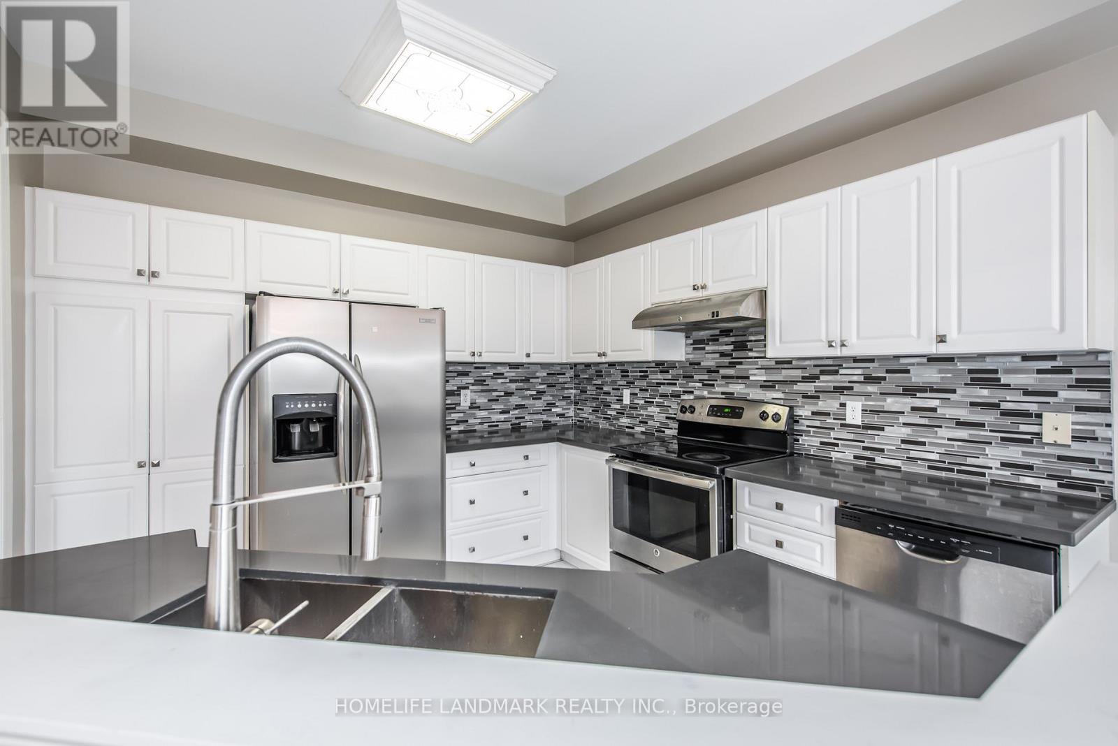 A modern kitchen with a stainless steel sink and countertop.