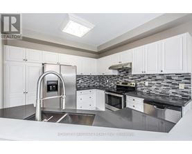 A modern kitchen with a stainless steel sink and countertop.