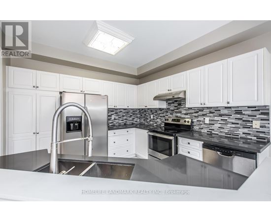 A modern kitchen with a stainless steel sink and countertop.