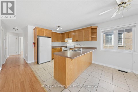 A kitchen with wooden cabinets and a white refrigerator.