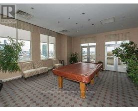 A large room with a brown table and a sofa.