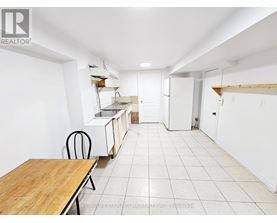 A white room with a table and chairs in it.