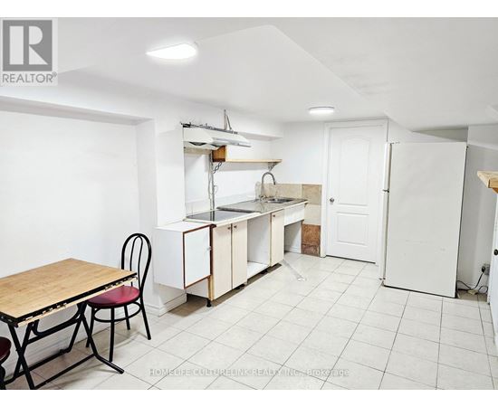 A kitchen area with a table and chairs.
