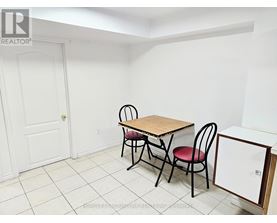 A small dining room with a table and chairs.