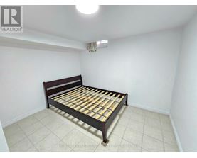 A bedroom with a bed and a ceiling light.