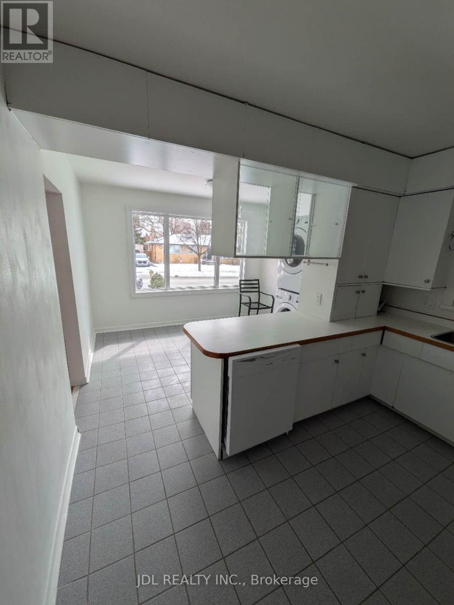 A kitchen with white cabinets and a large island.