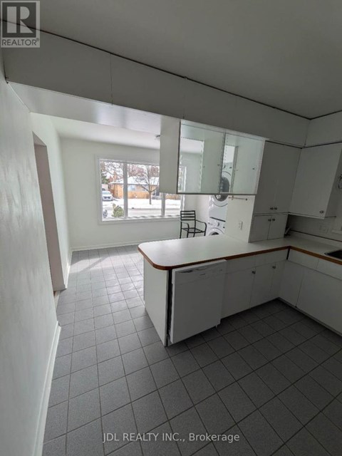 A kitchen with white cabinets and a large island.