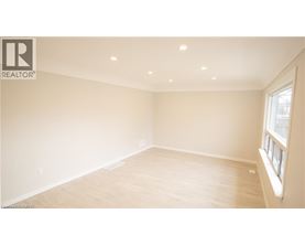 A spacious room with a window on the right side.