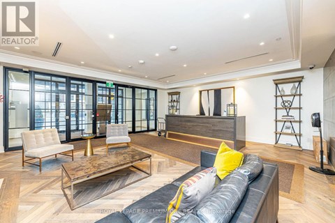 A living room with a black couch and a coffee table.