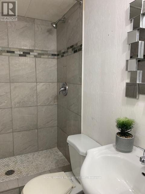 A white toilet sits next to a sink in a bathroom.