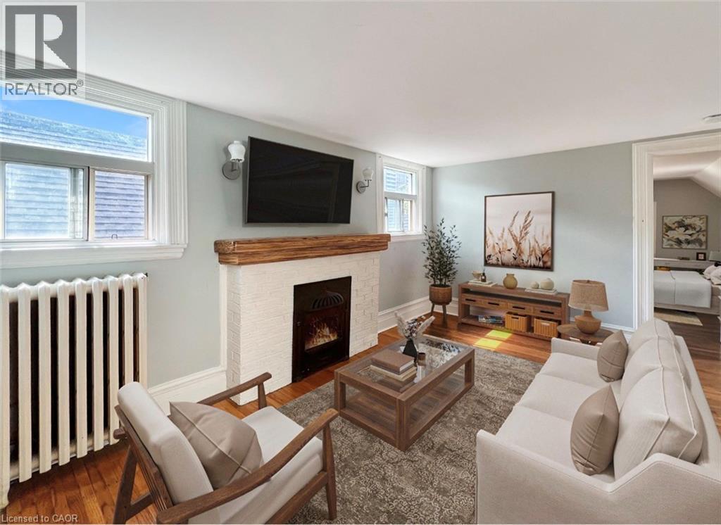 A living room with a fireplace and a flat screen TV mounted above it.
