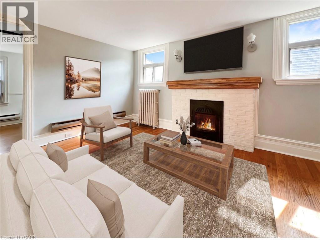 A living room with a fireplace and a flat screen TV mounted above it.
