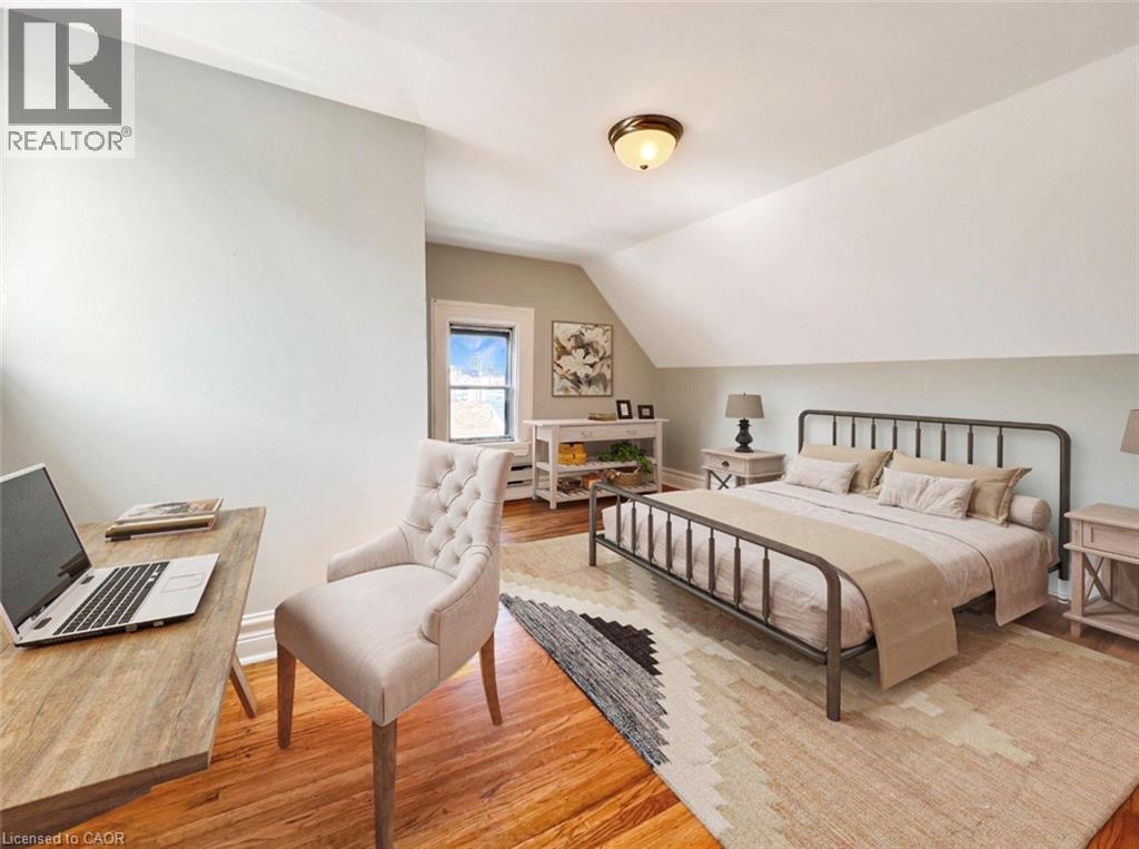 A bedroom with a bed, chair, and desk.