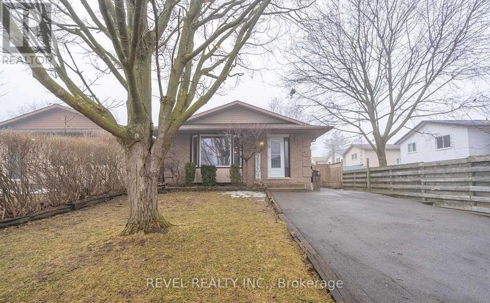 A house with a tree in front of it is for sale.