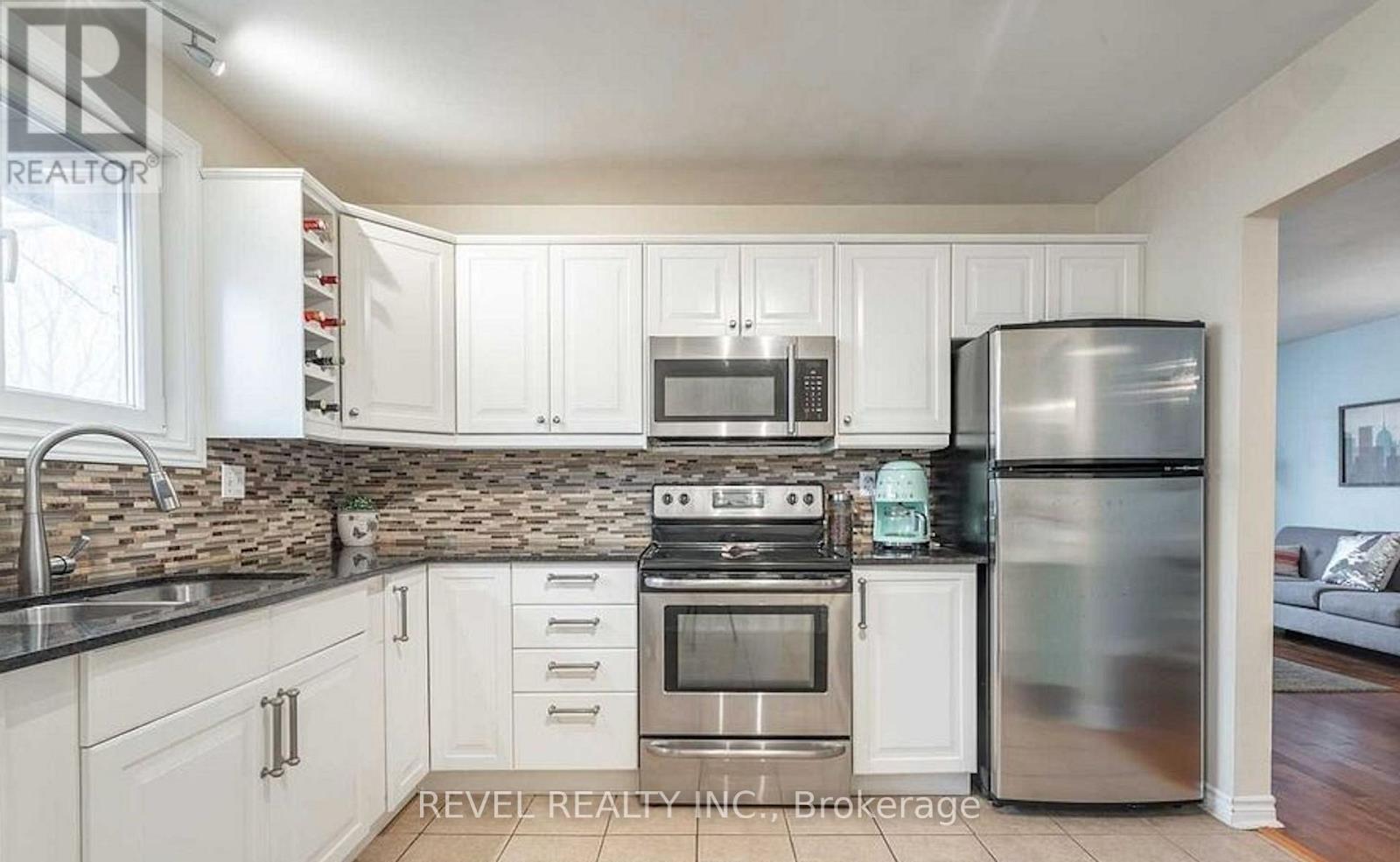 A kitchen with white cabinets and stainless steel appliances.