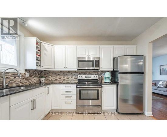 A kitchen with white cabinets and stainless steel appliances.