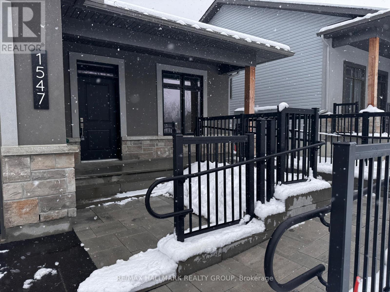 A snowy scene with a house number 1547.