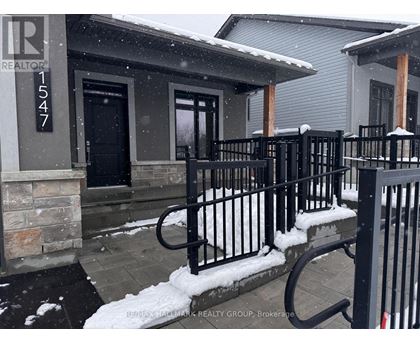 A snowy scene with a house number 1547.