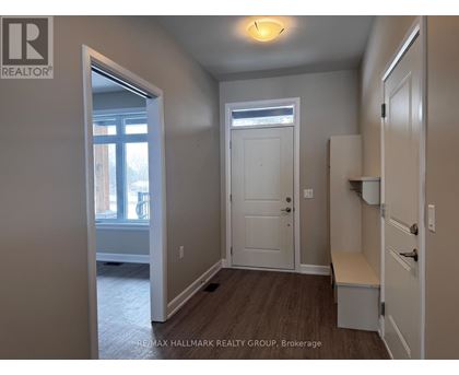A room with a door, a window, and a bench.