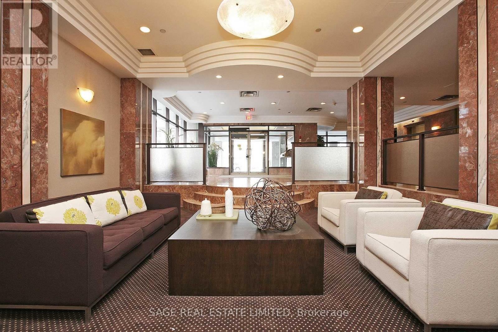 A living room with a brown couch and a white couch.